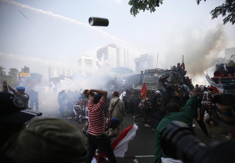 fot. Darren Whiteside / Reuters / 21 sierpnia 2014  Dżakarta, Indonezja  Indonezyjska policja wykorzystuje gaz łzawiący i armaty wodne do rozproszenia osób popierających opozycyjnego kandydata na prezydenta.